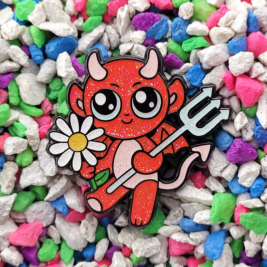a smiling cute kawaii devil holding a pitchfork and presenting a daisy flower.