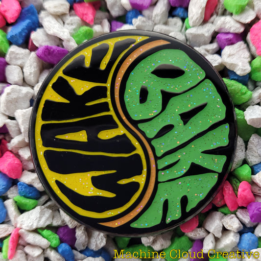 Enamel pin of yin yang sign that says wake on one side and bake on the other.